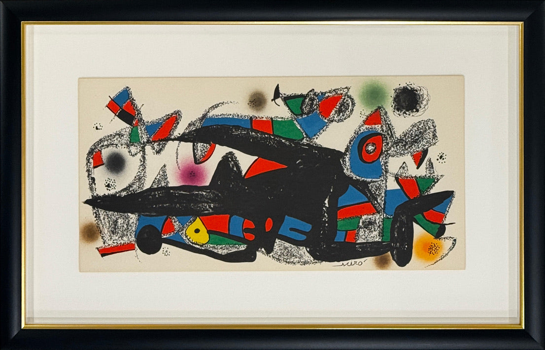 A framed abstract art print featuring a dynamic composition of black, red, blue, green, yellow, and gray shapes on a cream background, enclosed in a white mat and a black frame with a gold inner trim.