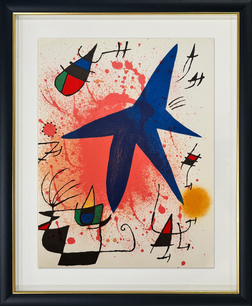 Framed abstract art print featuring a large blue star-like shape over a red and orange splattered background, with black gestural lines and small colored geometric forms. The print is mounted with a white mat and enclosed in a black frame with a gold inner trim.