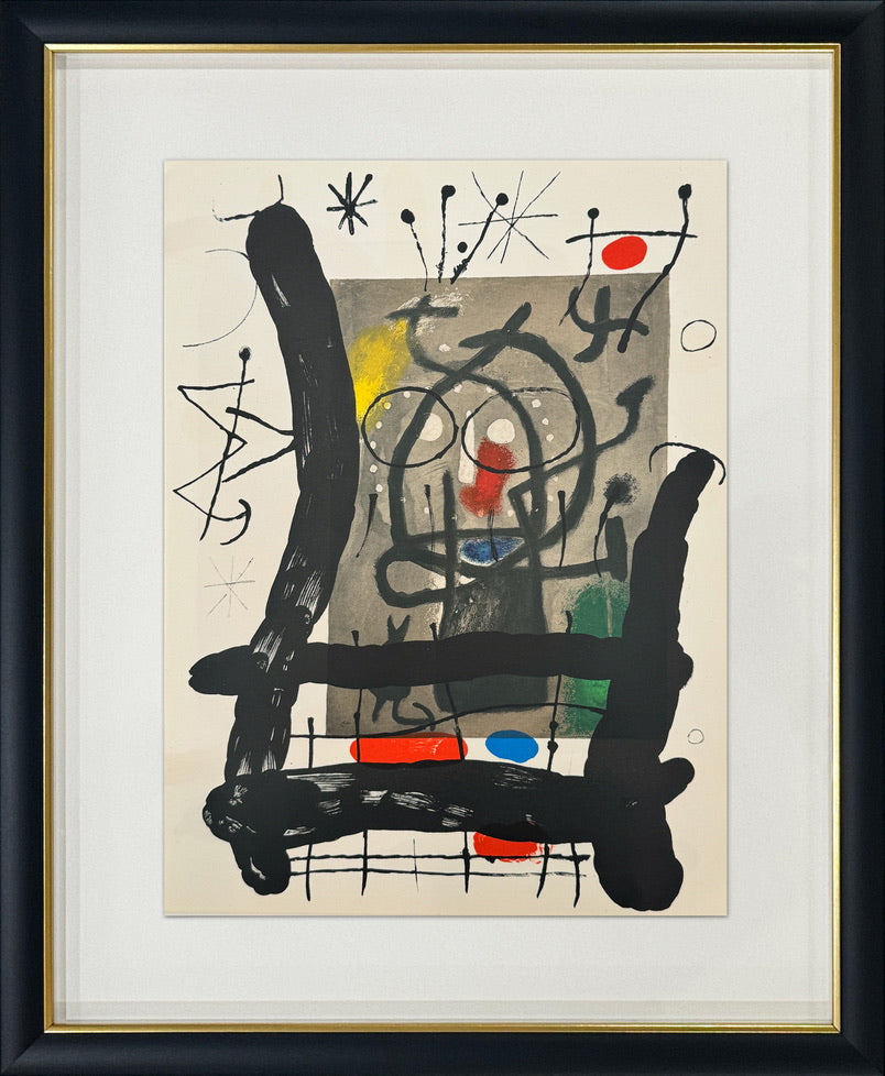 Framed abstract art print featuring bold black gestural brushstrokes, red and blue accents, and a beige background, presented with a white mat and a black frame with a gold inner trim.
