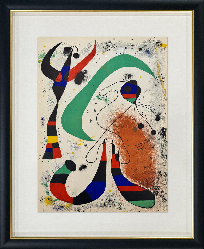Framed abstract art print featuring bold curved shapes and splatters in green, red, blue, black, and orange on a cream background, enclosed in a white mat and black frame with a gold inner trim.