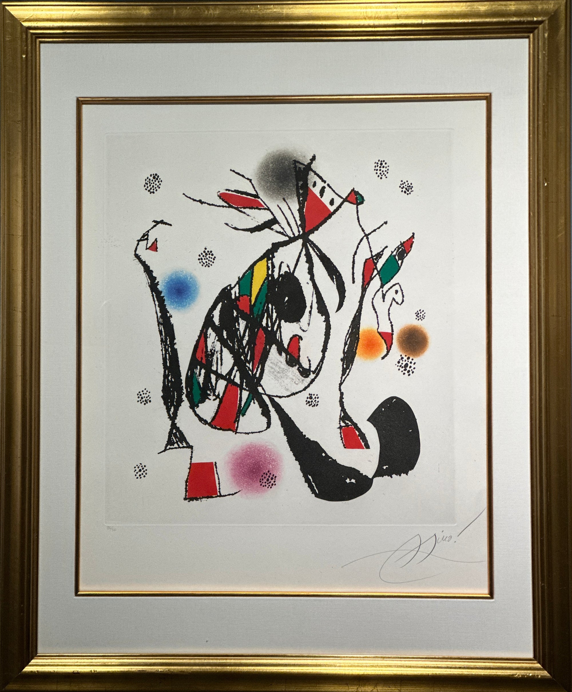 Framed abstract art print featuring a stylized figure in black, red, green, yellow, and blue on a white mat, enclosed in a gold frame.