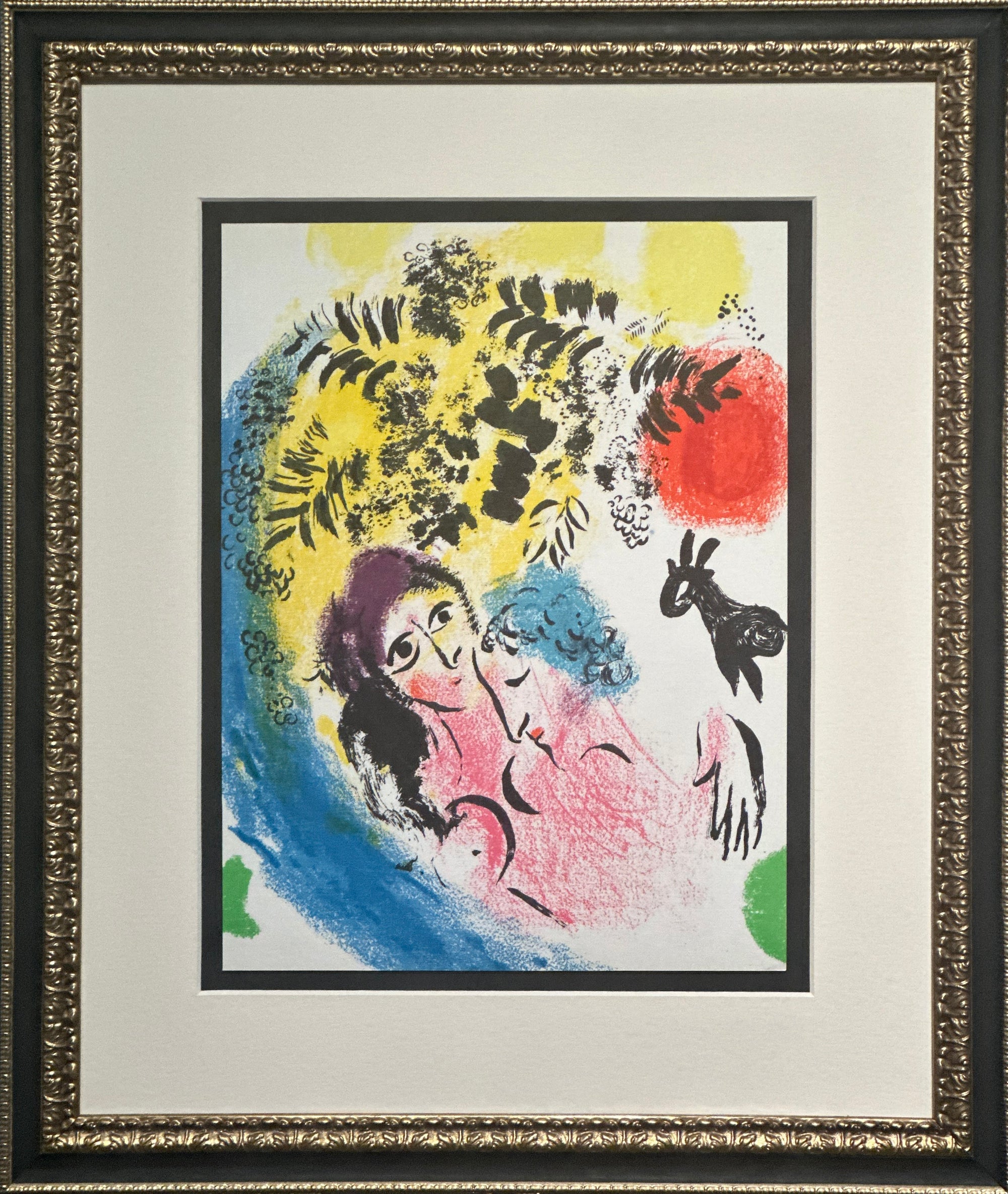 Framed abstract art print featuring two stylized faces with expressive black line work and bold splashes of yellow, red, blue, pink, and green on a white background, surrounded by a wide white mat and ornate dark frame.