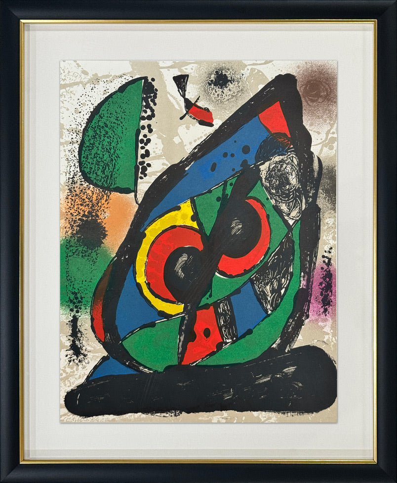 A framed abstract art print featuring bold, colorful organic shapes and circular forms in green, blue, red, yellow, black, and beige, presented in a black frame with a white mat and gold inner trim.